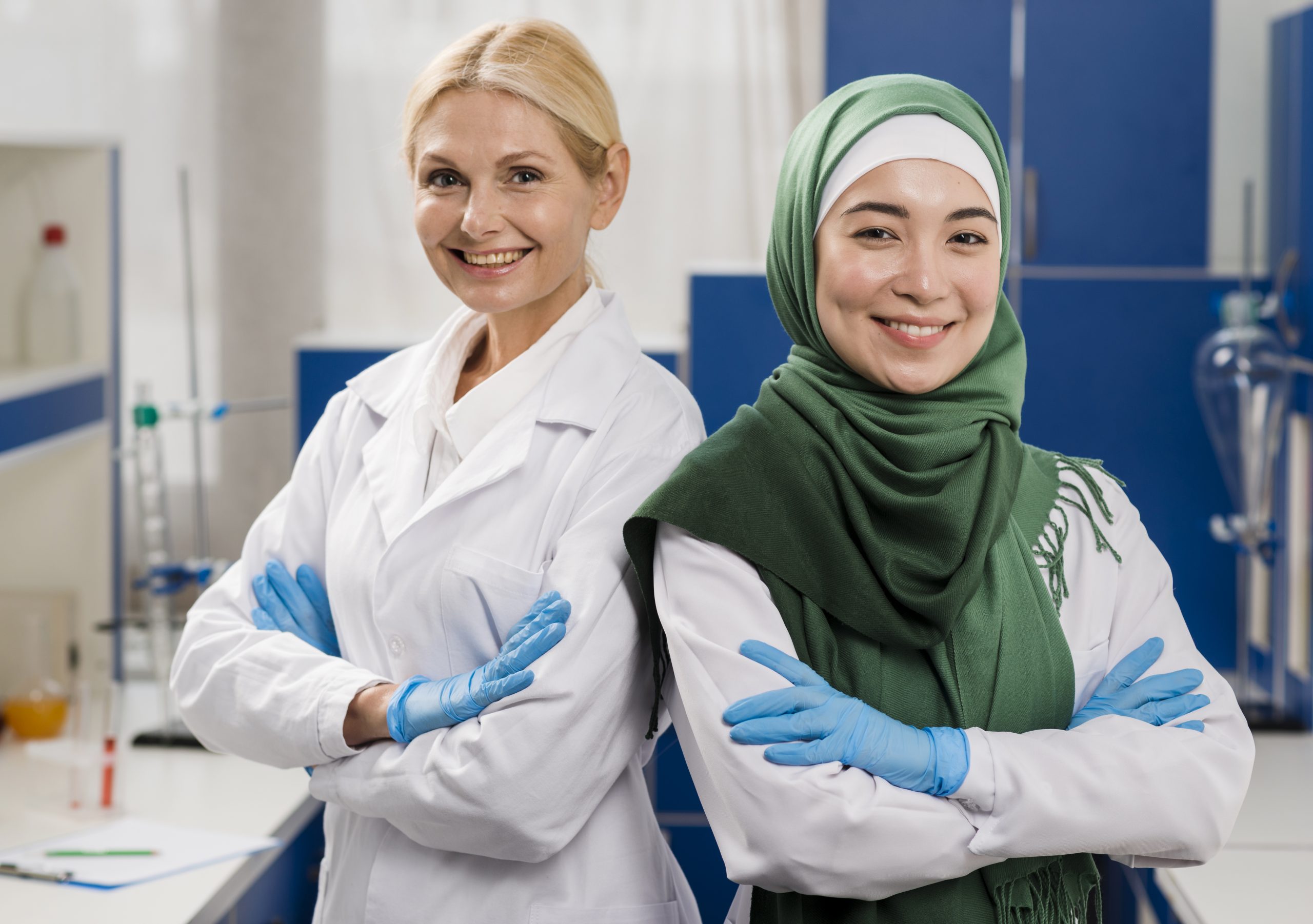 front-view-smiley-female-scientists-lab-posing-with-arms-crossed (1)